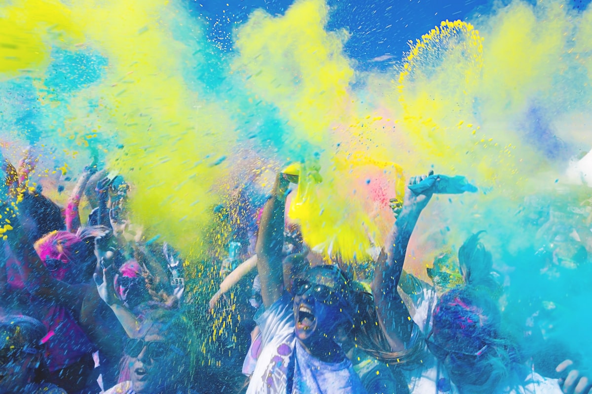 Holi festival India with crowds throwing colorful powder in the air